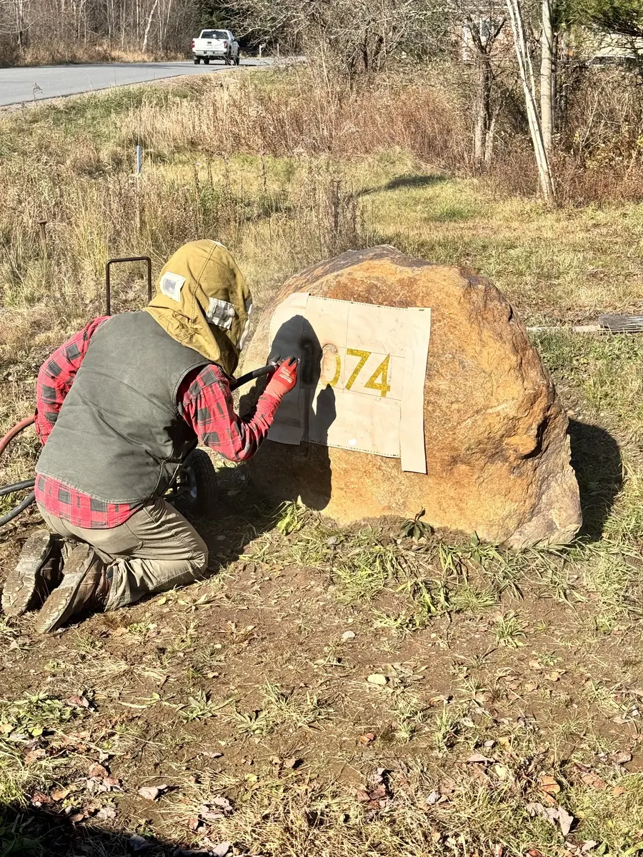 Sandblast engraving work on a boulder