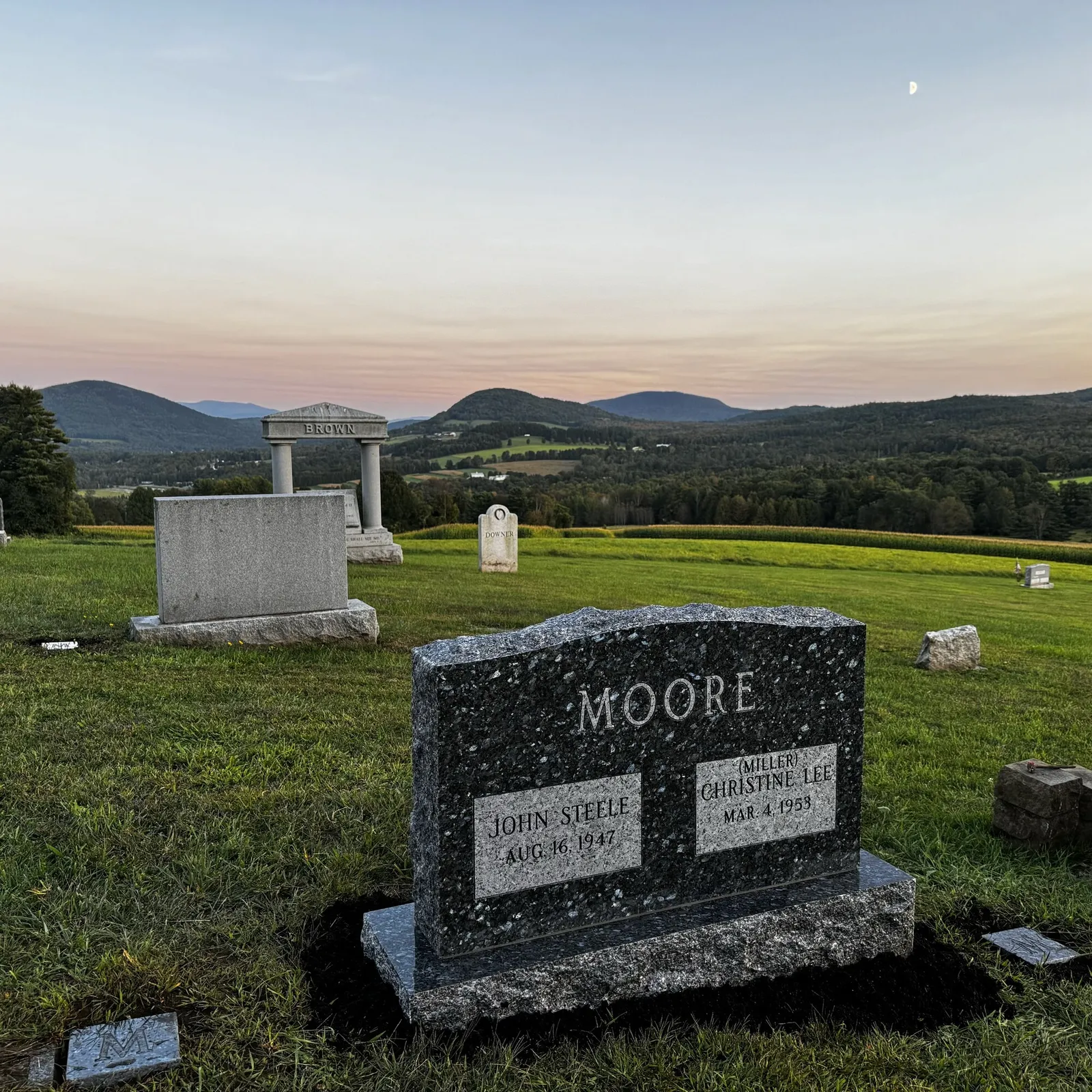A polished granite memorial standing in a Vermont cemetery